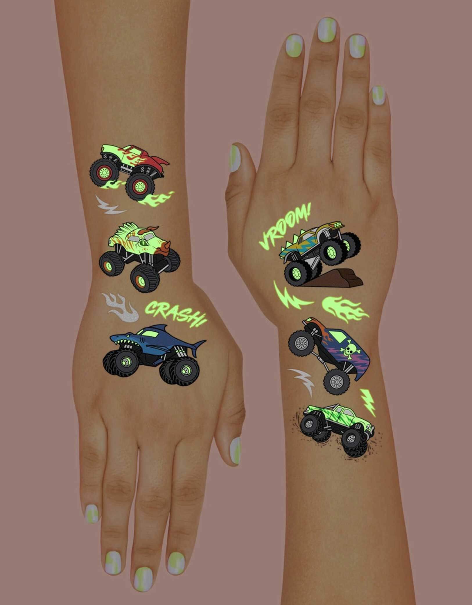 Two hands decorated with Momopartys's 8.25" x 6" Monster Truck Glow in the Dark Kids Temporary Tattoos by xo, fetti. Comes in a set of 50 tattoos, these awesome glow-in-the-dark Monster Truck temporary tattoos are guaranteed to be a wheel good time at your kid's Monster Truck birthday party! 50 designs means nobody gets left behind - invite all of your bffs to crash this party because these tats are sure to be fire!