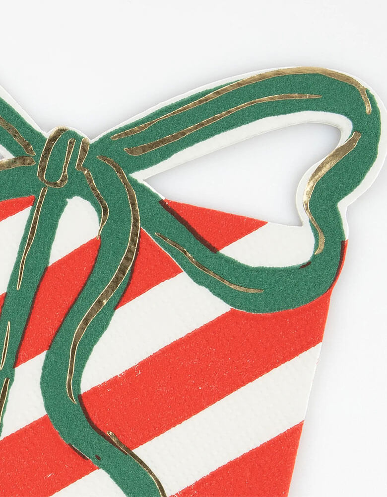 A close up shot of Momopartys's 5.25 x 6.5 inches Christmas present with bow shaped napkins by Meri Meri. Comes in a set of 16 napkins in 4 festive colors including red, pink, mint and green, these napkins with cut out bows, will make a stylish statement on your party table too. They're perfect for cocktail parties, festive drinks and meals.