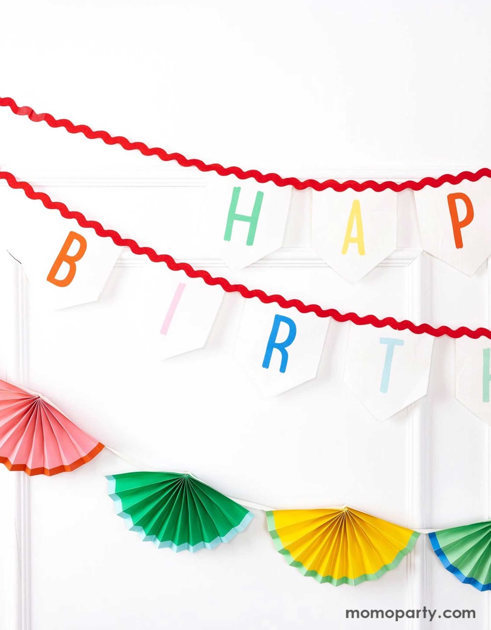 A white wall decorated with Momopartys's 6' Happy Birthday Felt Banner & colorful bunting garland by My Mind's Eye. Celebrate in style with these amazing Happy Birthday decorations! These banners will elevate any party with its vibrant design and premium felt material. Perfect for any birthday celebration, these cheerful decorations will bring joy and excitement to any special occasion. Check out momopartys.shop for more birthday party supplies now!