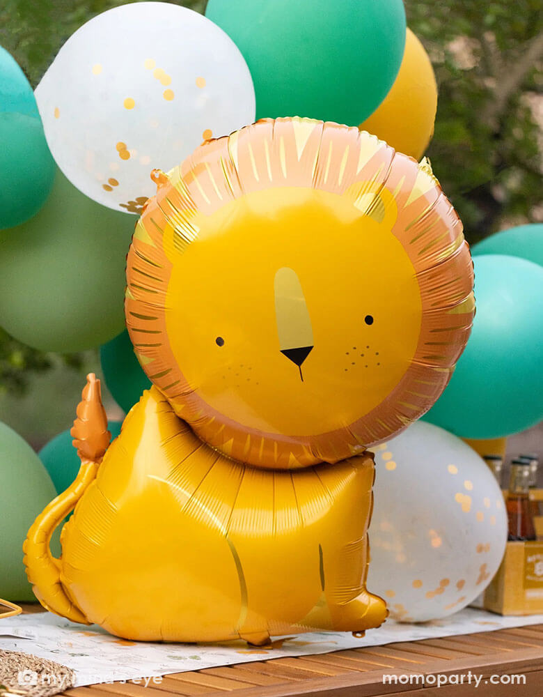 A kid's safari themed birthday party featuring Momopartys's 24" lion shaped foil mylar balloon by My Mind's Eye in front of a safari themed balloon garland. This charming lion shaped balloon adds the perfect amount of wild to a birthday celebration that will have your guests exclaiming "Oh My!" Perfect for kid's "Wild One" or "Two Wild" or "Young, wild and three" themed milestone birthday parties!