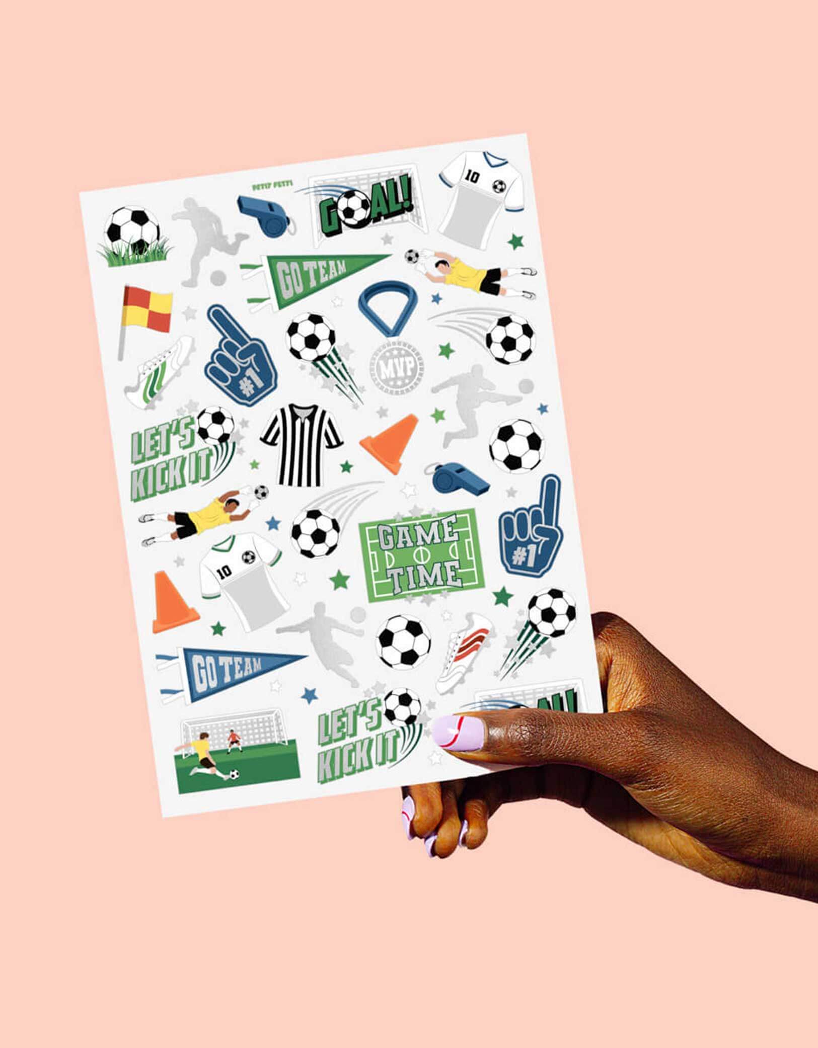 Momo Party's Soccer Kids Temporary Tattoos by Xo, Fetti. Comes in a set of 54 tattoos in soccer themed designs including soccer balls, MVP medals, soccer fields, soccer cleats, soccer jerseys, training cones, soccer players, these soccer temporary tattoos are great for kid's soccer themed birthdays or a watching parties.