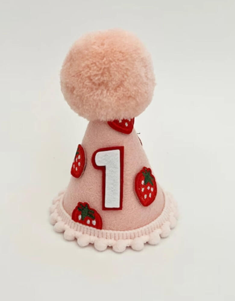 Strawberry shortcake felt first birthday hat for girls from momopartys.shop. Adorned with sweet strawberries and playful pom poms, this pink felt hat adds the perfect touch of cuteness to any party outfit. A must-have for any girl's special day.