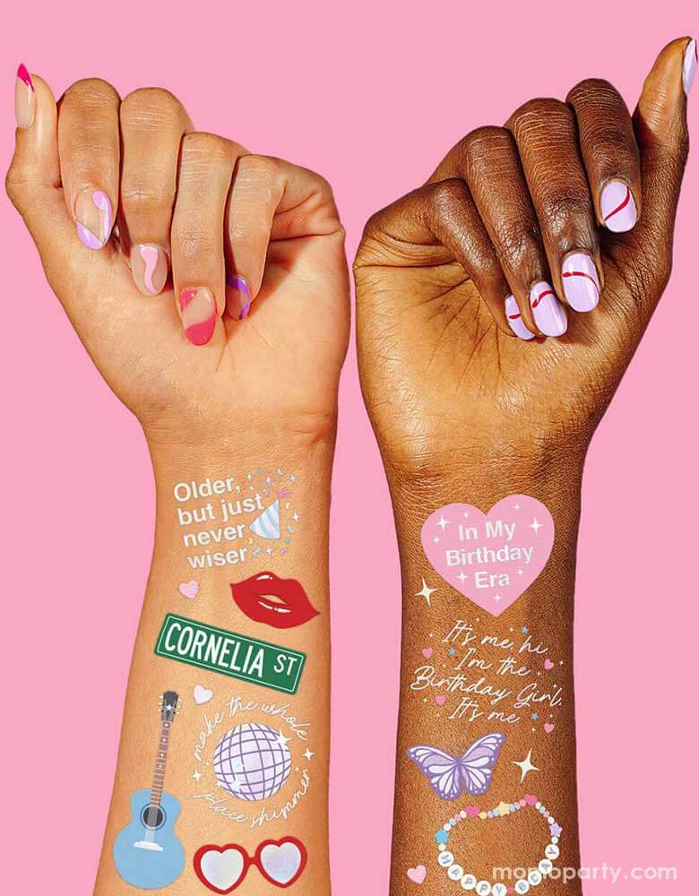 Two girls' arms decorated with Momopartys Birthday Taylor Swift Era Temporary Tattoos by Xo, Fetti. Featuring Taylor Swift inspired designs including the iconic Taylor Swift-themed designs including snakes, butterflies, red lipsticks and more. They're perfect for girl's Taylor Swift themed birthday party activities.