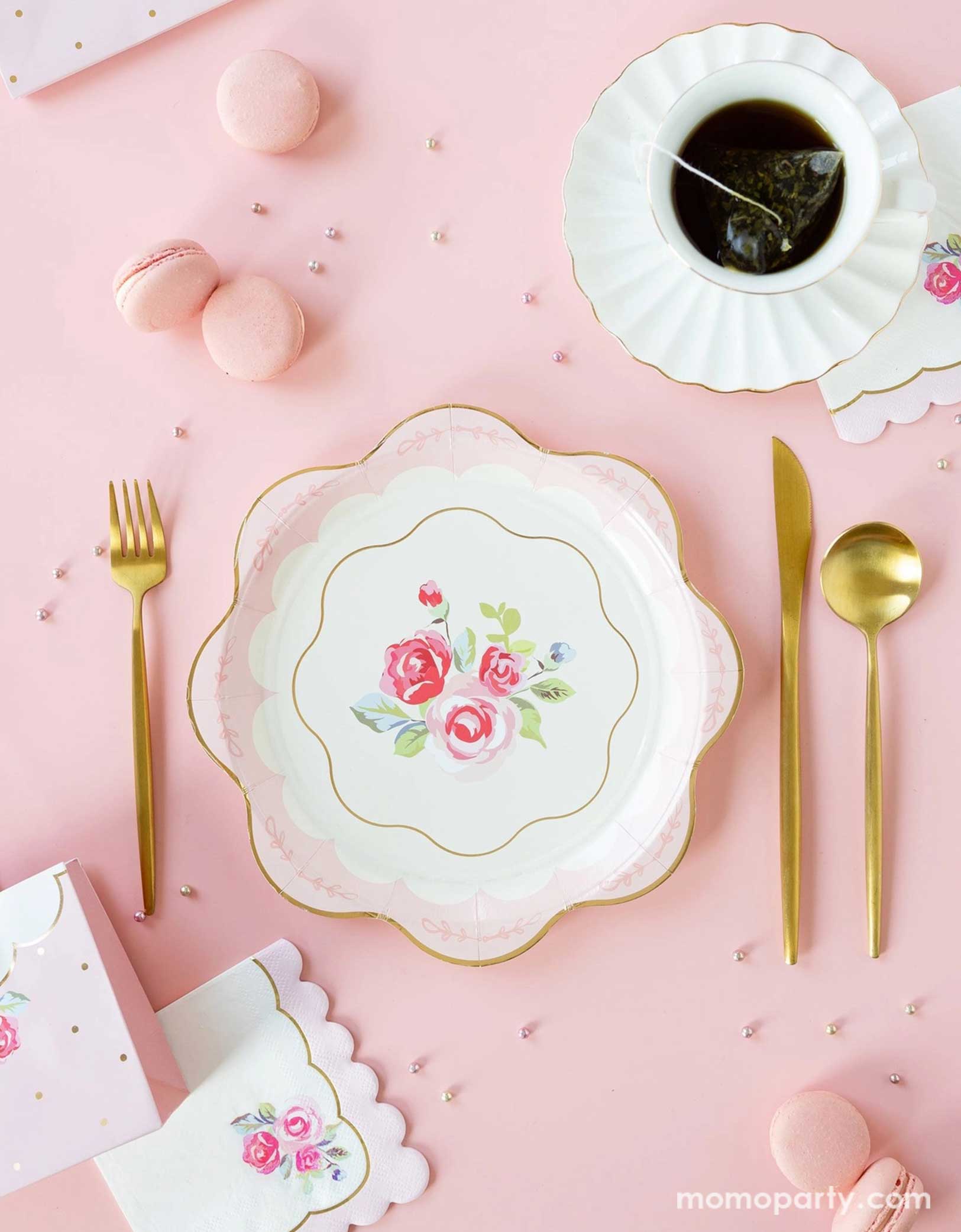 Elevate your tea party with Momopartys's Tea Party themed party supplies by My Mind's Eye. This elegant setup features tea party rose scallop-edged plates, rose corner small napkins, golden utensils. Along with a tea cup set with gold foil edge and pink macarons on a soft pink backdrop. Perfect for bridal showers, baby showers, or whimsical tea parties, these Teat Party supplies add a touch of charm and sophistication to any celebration. Check out momopartys.shop for more!