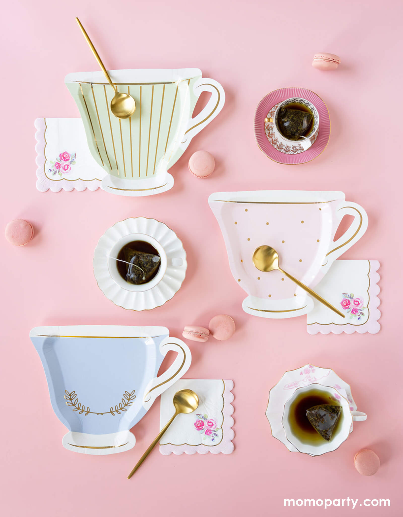 Elevate your tea party with Momopartys's 10" Tea Party Cup Shaped Paper Plate Set by My Mind's Eye. This elegant setup features pastel-colored tea cup-shaped plates with gold accents, paired with floral scalloped napkins, golden teaspoons, and pink macarons on a soft pink backdrop. Perfect for bridal showers, baby showers, or whimsical tea parties, these 10" paper plates add a touch of charm and sophistication to any celebration. Shop now for stylish tea party supplies at momopartys.shop