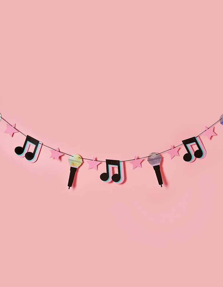  Momopartys's 6.5 ft let's day party banner featuring musical notes, microphone, pink star pennants by Hooty Balloo, with a pink background. This banner is perfect for a teenagers and preteens' dance party, Taylor Swift themed, or TikTok inspired party.