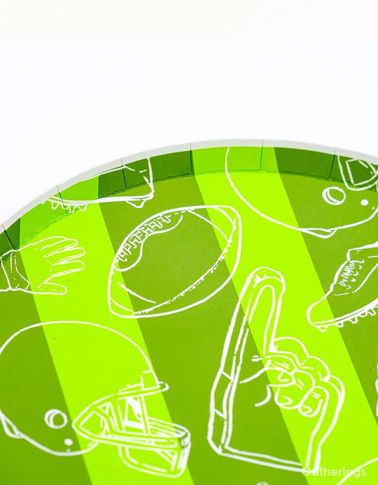 A close up shot of Momopartys's 8.5" Touchdown Dessert Plates by Gatherings. Elevate your game day celebration with these touchdown plates! These sturdy and stylish plates are the perfect addition to your football-themed party. With a unique design and high-quality materials, you and your guests can enjoy your favorite treats with ease. Score a touchdown with these plates and make your party a winner!