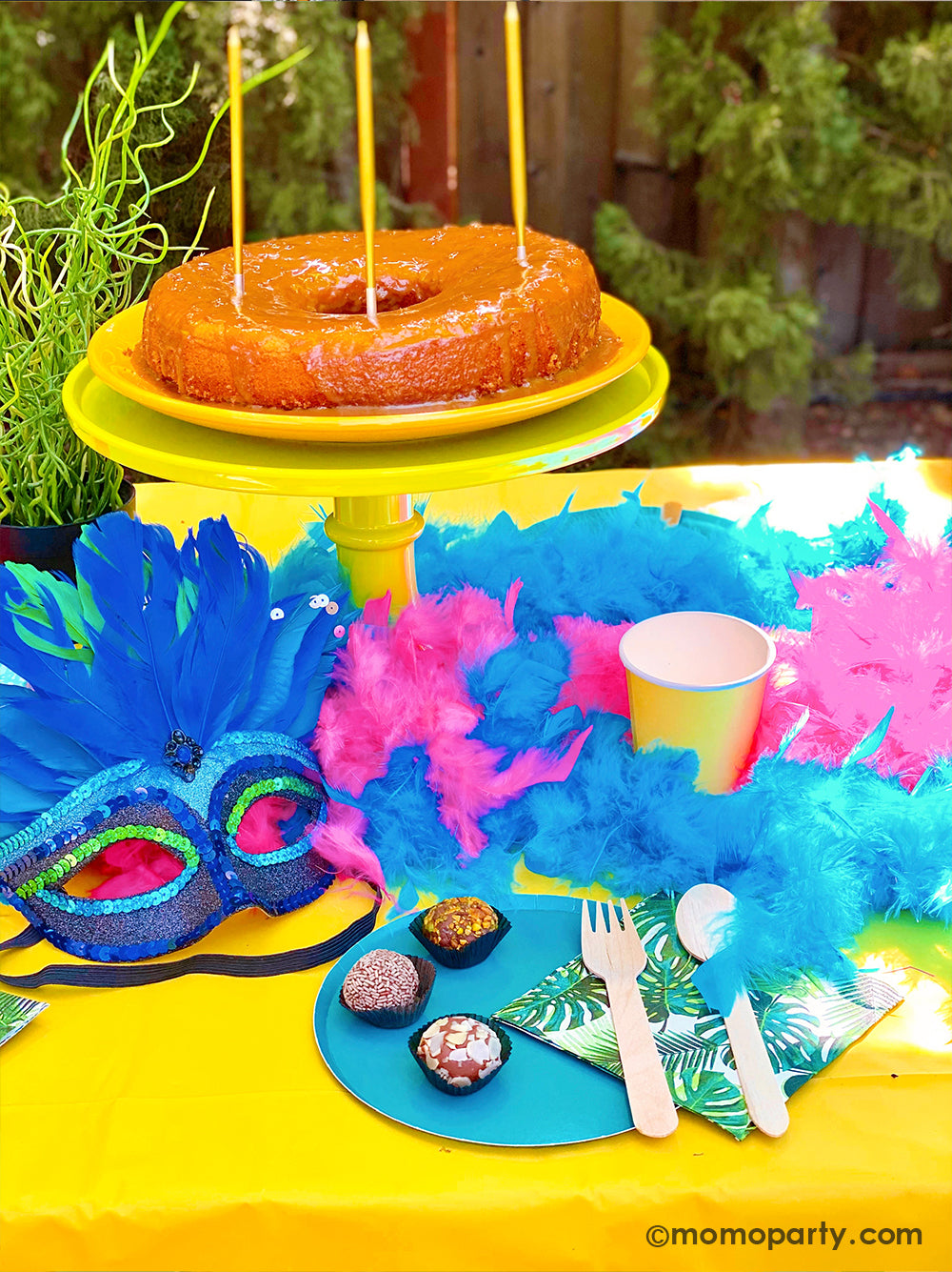 Get ready to throw the ultimate summer celebration with a vibrant Brazilian Carnival-themed party table! Featuring tropical party supplies from Momopartys, this festive setup includes palm leaf napkins, matching plates, and colorful party cups that bring the rainforest vibe to life. Complete the look with feather garlands, carnival masks, decadent chocolate desserts, and a stunning birthday cake. Whether it's for a birthday, summer bash, or themed event, this tropical party setup is perfect for summer!