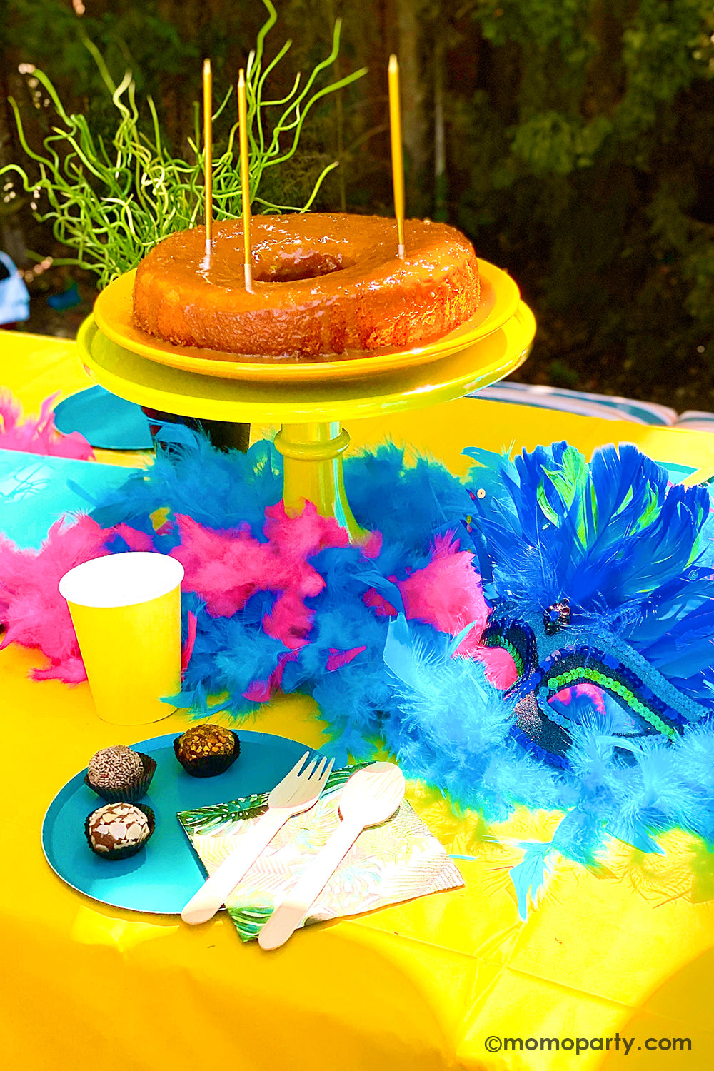 Get ready to throw the ultimate summer celebration with a vibrant Brazilian Carnival-themed party table! Featuring tropical party supplies from Momopartys, this festive setup includes palm leaf napkins, matching plates, and colorful party cups that bring the rainforest vibe to life. Complete the look with feather garlands, carnival masks, decadent chocolate desserts, and a stunning birthday cake. Whether it's for a birthday, summer bash, or themed event, this tropical party setup is perfect for summer!