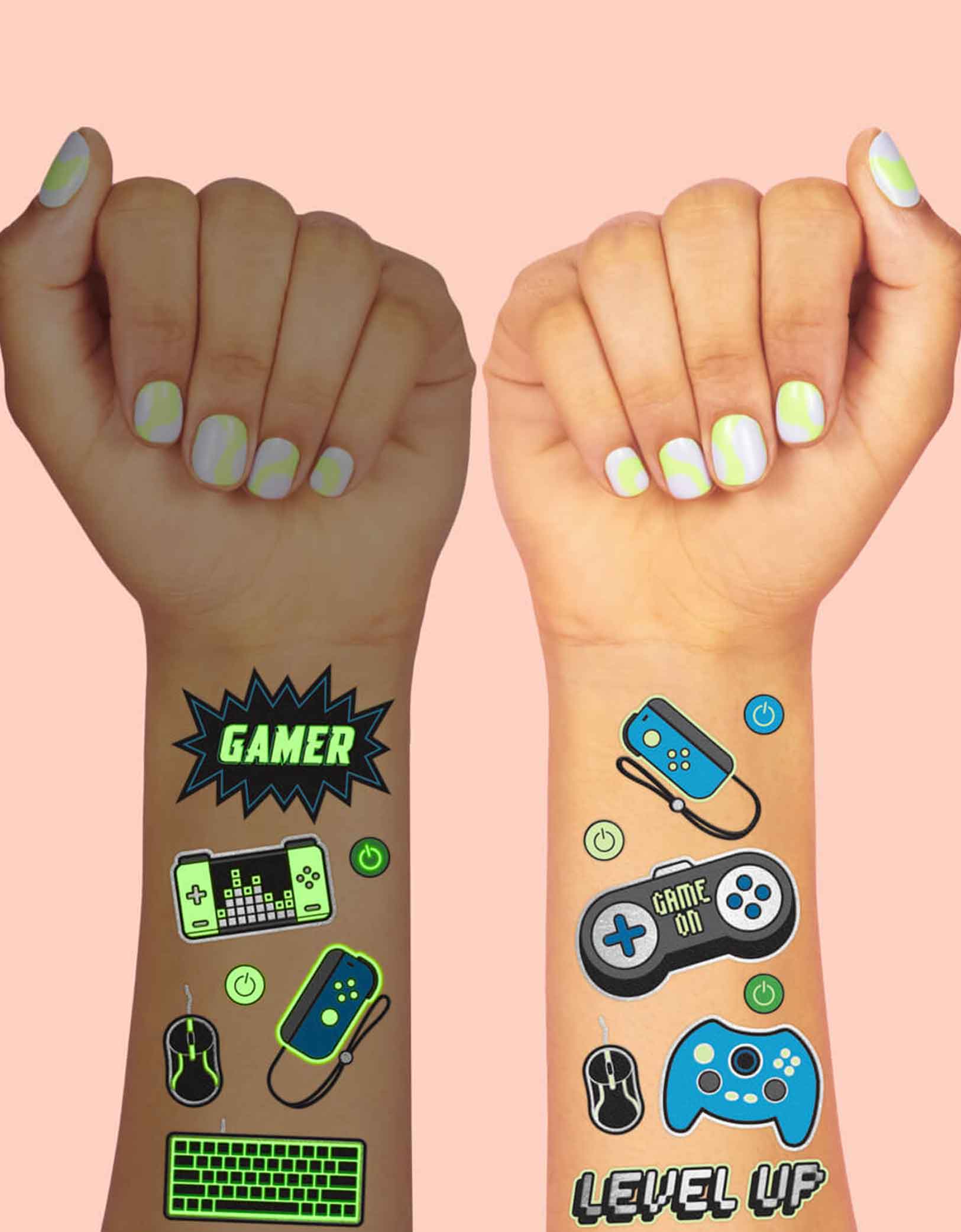 Two arms decorated with Momopartys's Video Gamer Glow in the Dark Kids Temporary Tattoos by xo, Fetti. Comes in a set of 40 tattoos, these glow in the dark video game temporary tattoos are the perfect kids after school activity or a video game themed party accessory! 40 designs including game controllers, game devices, level up, game over signs means no gamer gets left behind - call all the players, its game on!