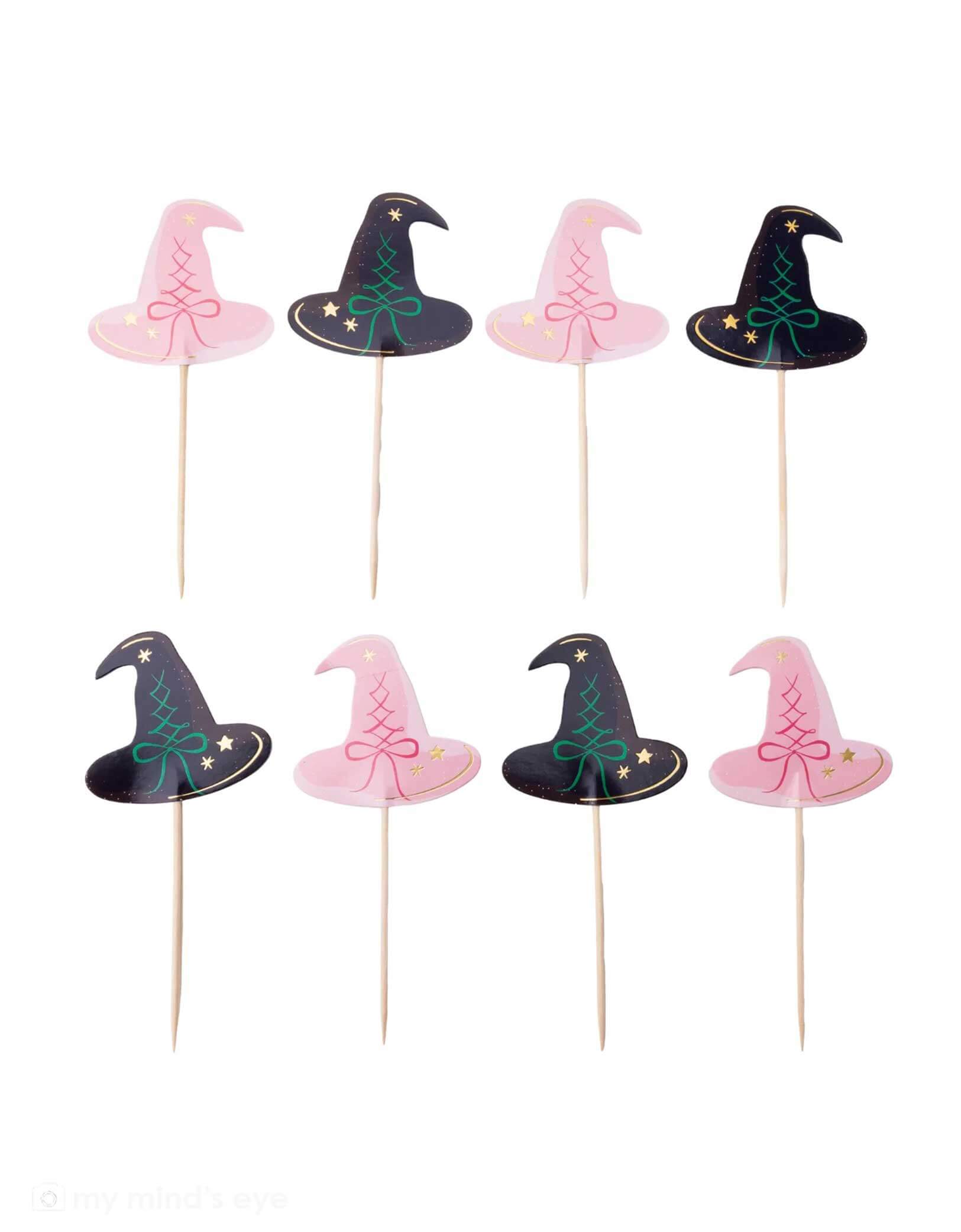 A set of witch hat cake toppers on sticks with pink and black designs from Momopartys, on a white background. These toppers are perfect for a Wicked themed party.