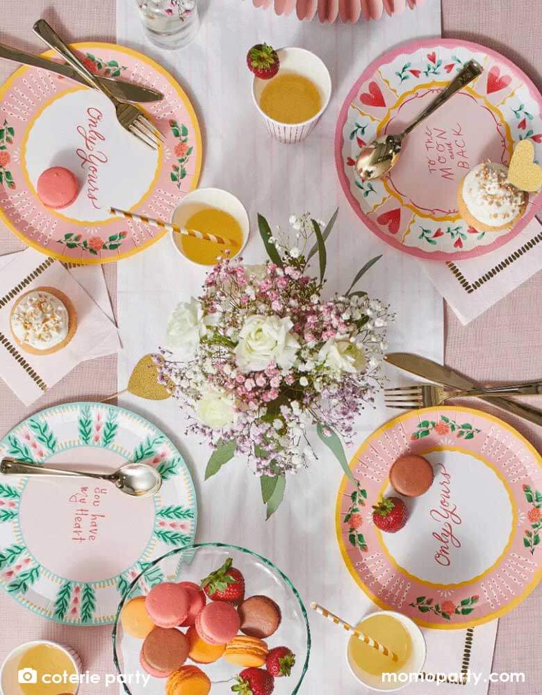 A beautiful table set with Momopartys's 9" "All you need is love" round plates featuring 3 designs with messages including "To the Moon and Back," "Only Yours," "You Have my Heart" on the plates, they are prefect for a love themed celebration or a Valentine's Day party.