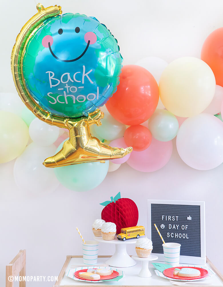 Momopartys - Morden Back To School Party inspiration with Anagram Back To School Globe Foil Mylar Balloon, 6ft long Balloon Garland Assorted in Pastel Yellow, Pink, Mint, Carol, White Latex Balloon for Backdrop decoration, Letter board with "First Day of School" sign, Oh happy day Cherry Red side plate, Aqua Striped Large Plates and cups, Leaf Napkins as tableware, Honeycomb Apple, cupcakes, and school bus toy on cake stand 