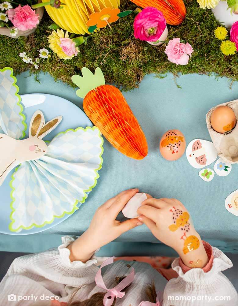 A beautiful Easter table decorated with lots of spring flowers and honeycomb carrot and Easter egg decorations as centerpiece, with Momopartys's 5 x 6.3" bunny napkins by Party Deco, it makes a great inspiration for an adorable kid's Easter tableset.