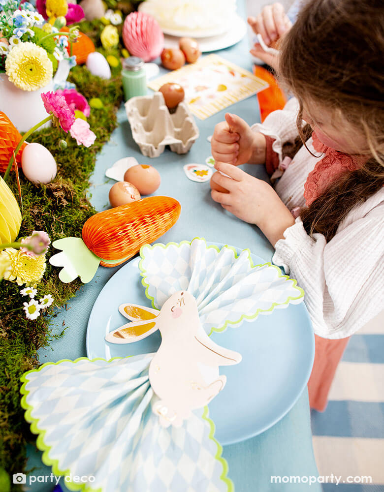 A beautiful Easter table decorated with lots of spring flowers and honeycomb carrot and Easter egg decorations as centerpiece, with Momopartys's 5 x 6.3" bunny napkins by Party Deco, it makes a great inspiration for an adorable kid's Easter tableset.