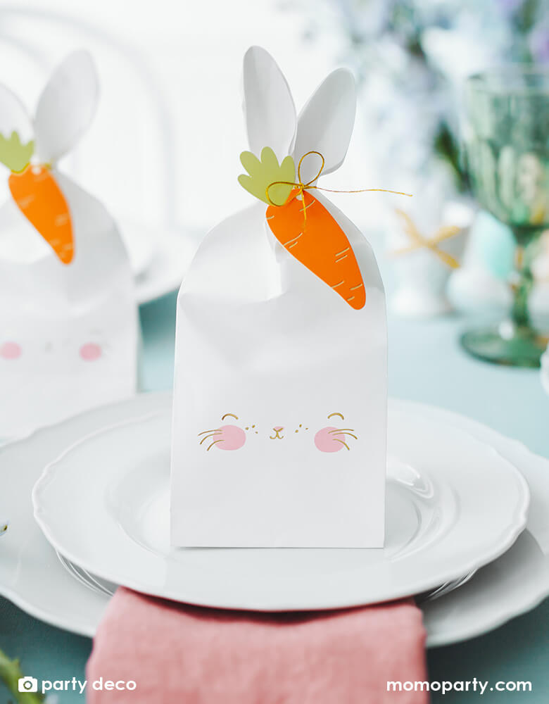 A beautiful Easter table set with Momopartys's 2.95 x 3.5 x 8.8" bunny treat bags by Party Deco. A perfect idea for Easter party table with kids.