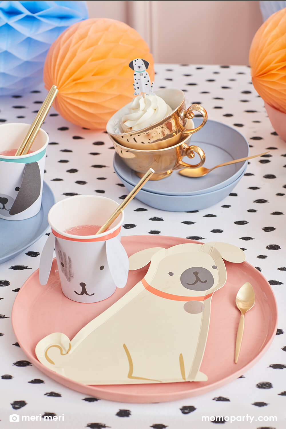 Momopartys kid's puppy dog themed birthday party table, filled with Pug Plates on a croal round plate, Puppy Cup with gold foil straws,  Puppy cupcake topper on the cupcake in the cups, honeycombs all on the black dots tablecloth,  The modern and cute design party supplies from Meri Meri of Cat and Dog Collection,will make an Insta-perfect party table for your kid's puppy or dog themed birthday party.