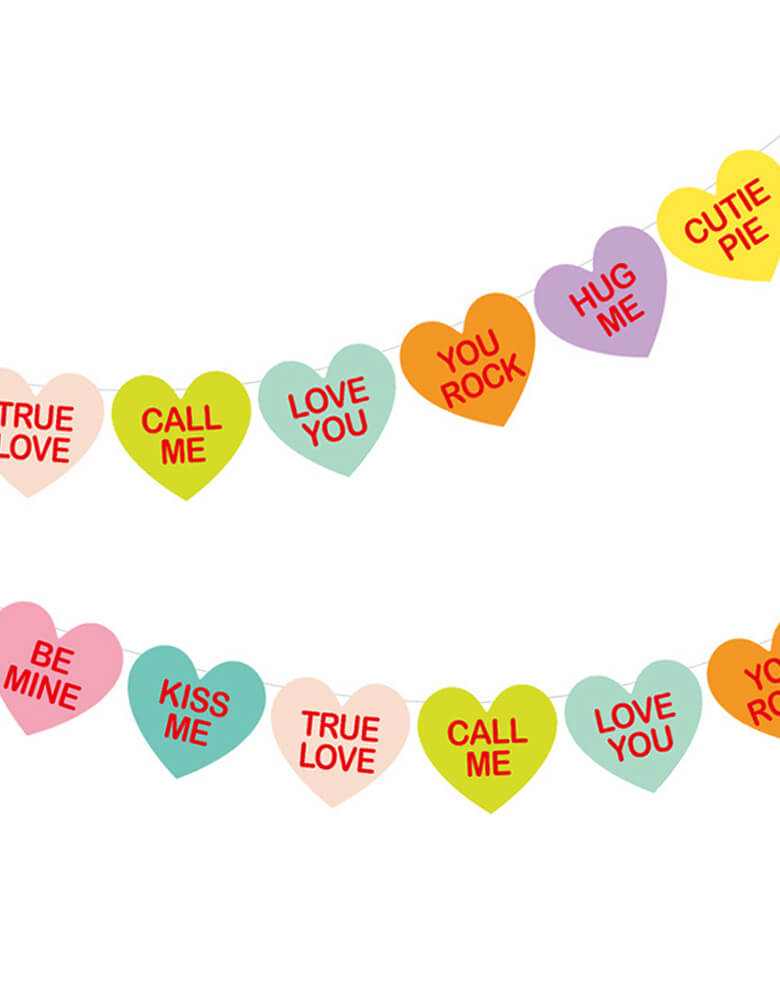 Momopartys - Conversation Hearts Banner Set. With 8 different sayings including "Hug Me", "Text Me", "Wink Wink", "Be Mine", "Kiss Me", "You Rock", "U R Cute", and "Love You", this banner is double printed and pre-strung which makes decorating V-day easy as 1-2-3!  This banner set is the perfect accessory for your Valentines Day or Galentine's Day celebration!