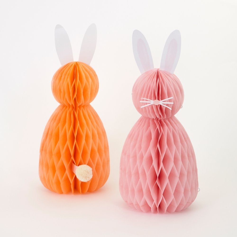 Meri Meri - Easter Honeycomb Decorations. Close up look of back look of orange bunny with amazing paper tissue honeycomb details, paper ears and pompom tail.  Front look of A pink honeycomb bunny with paper ears, nose and whisker stickers. This high quality easter decoration is perfect for your easter party table, spring party, farm themed party, easter basket decorations, home decoration for easter.