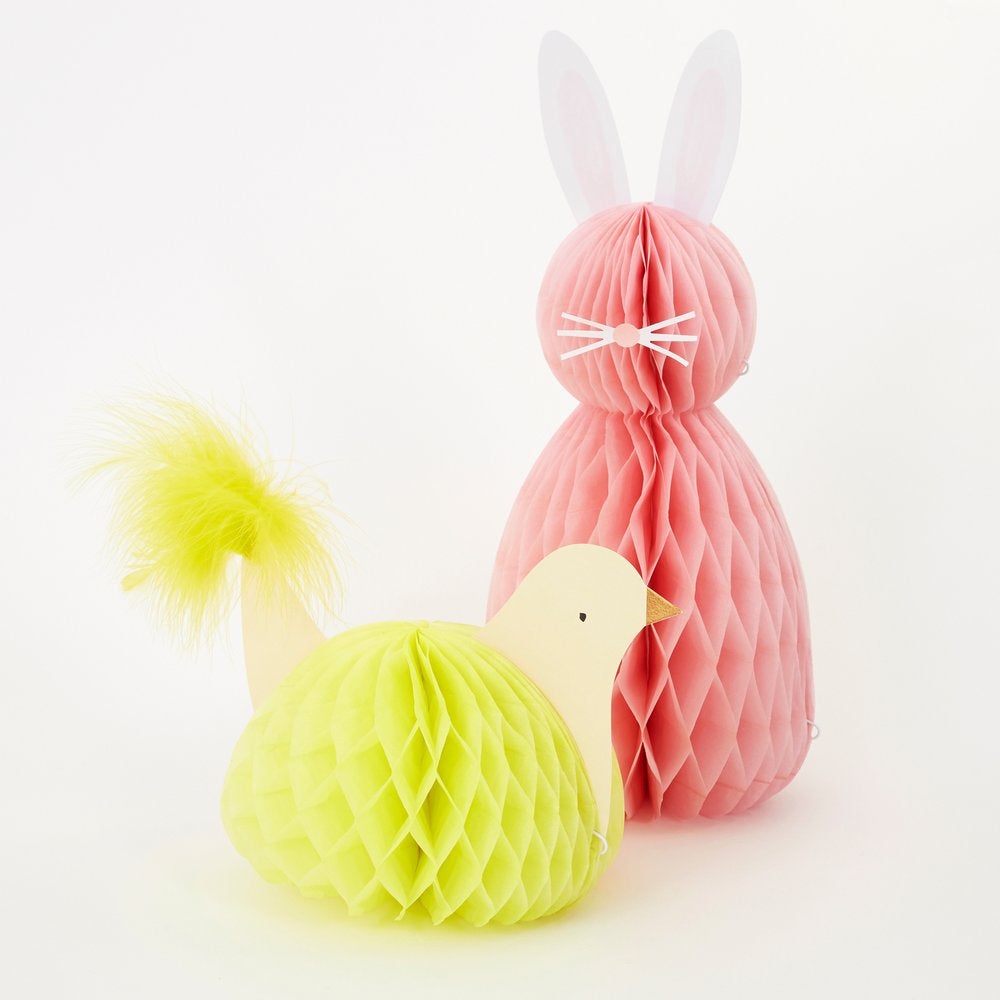 Meri Meri - Easter Honeycomb Decorations. Close up look of A chick adorned with amazing paper tissue honeycomb details and a fluffy tail feathers.  A pink honeycomb bunny with pompom tails, paper ears, nose and whisker stickers. This high quality easter decoration is perfect for your easter party table, spring party, farm themed party, easter basket decorations, home decoration for easter.