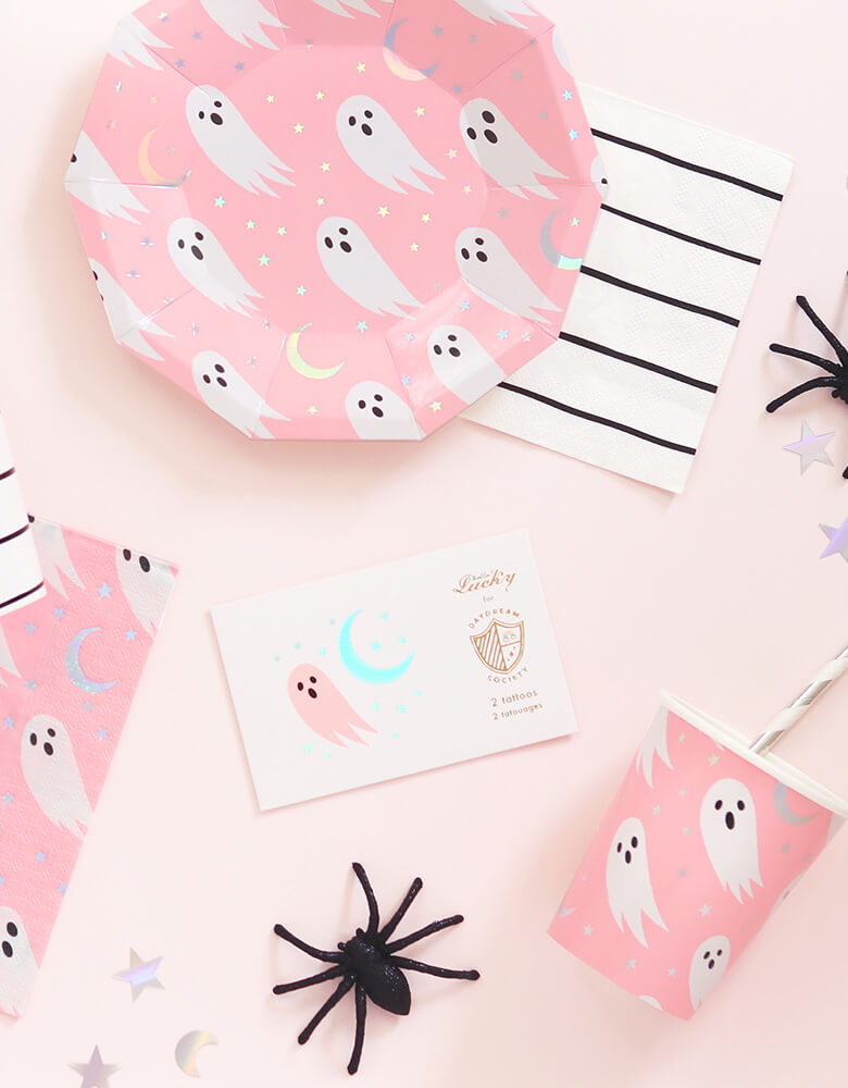 A table of Daydream Society's Halloween Spooked collection of Party Supplies featuring ghosts in holographic foil and neon pink design