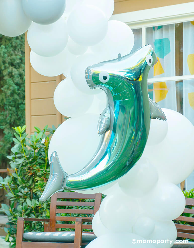 Under the sea yard party of Anagram 41" Hammerhead Shark Foil Balloon over the white blue tone of balloon garland arch. Party planning, partywares and Photo by Party Boutique Online at momopartys.shop