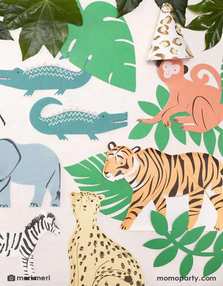 A jungle collage scene made with Momopartys's safari jungle themed tableware including a 11.375 x 7.5" tiger shaped plate, a monkey shaped napkin, two alligator shaped napkins, a cheetah shaped plate, a 7 x 5.75" elephant shaped napkin, and a zebra shaped napkin, along with some palm leaf paper cut decorations, it makes a great inspiration for kid's animal themed party, a "Wild One" 1st birthday party or a "Two Wild" themed second birthday party.