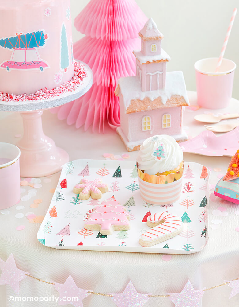 Momopartys Holiday Christmas Falala Holiday Table set up look with a pastel pink christmas tree, candy cane, pink snowflake cookies, cupcake with Blush Striped Food Cups on My minds eye's Falala Christmas Tree Plates, strawberry milk in the Pale Pink Tumbler Cup, Fa La La Christmas Tree Plates, pink buttercream cake with Let's Get A Tree! Cakescape Edible Stickers, Pink, Coral and Blush Candy Artisan Confetti on the table, StudioPep Pink Glitter Star Banner on the side of the table for a cozy celebration