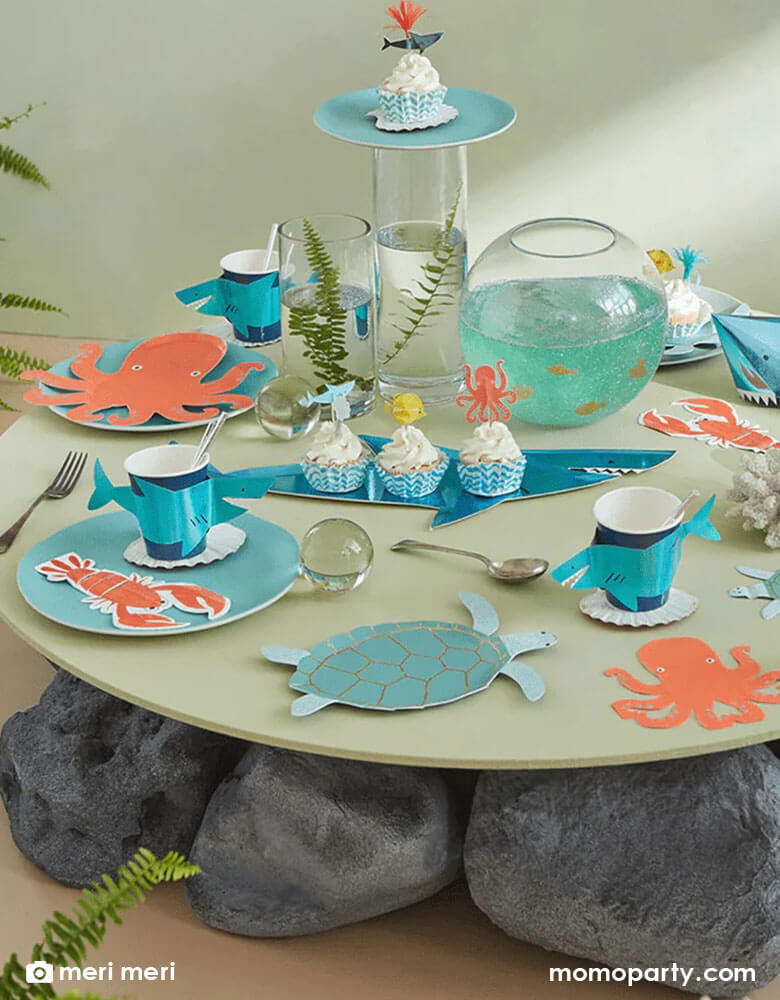 A festive party table filled with Momopartys's sea collection by Meri Meri, featuring tableware in sea creature designs including turtles, octopus, lobsters, sharks, it makes great inspiration to kid's under the sea themed parties.