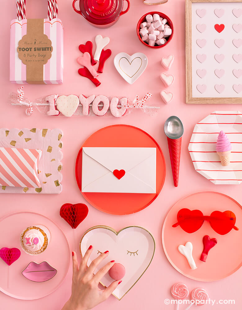 super sweet Valentines day collection pink table, full of pink and red paper plates, heart shaped plates, heart shaped latex balloon, red stripe paper plates, heart shaped sunglass, I heart you candy, toot sweet pink stripe party bags,  LE CREUSET Mini Round Cocotte, red ice cream cone shaped scoop, heart letter box, candies, cotton candies, Macarons for a sweet valentine's day party, Rom-Com Movie Night, Galentine's Day