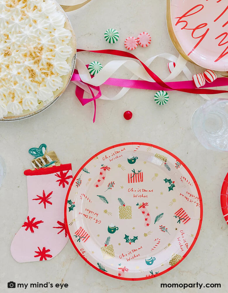 Pretty pink Christmas stocking napkins from My Minds Eye to make wishes come true for all!Cute die cut stocking shape is soft and whimsical and a beautiful table piece. The napkins are a modern pink color with red starbursts and even a stuffed toy with gold foil accents and a green bow! There are 18 napkins sized 4.5 x 6.5 inches. Pair beautifully with Christmas wishes and holiday plates at momopartys.shop. Add peppermint twists, kisses, candycane, hot cocoas and marshmallows for a cozy fun holiday table.
