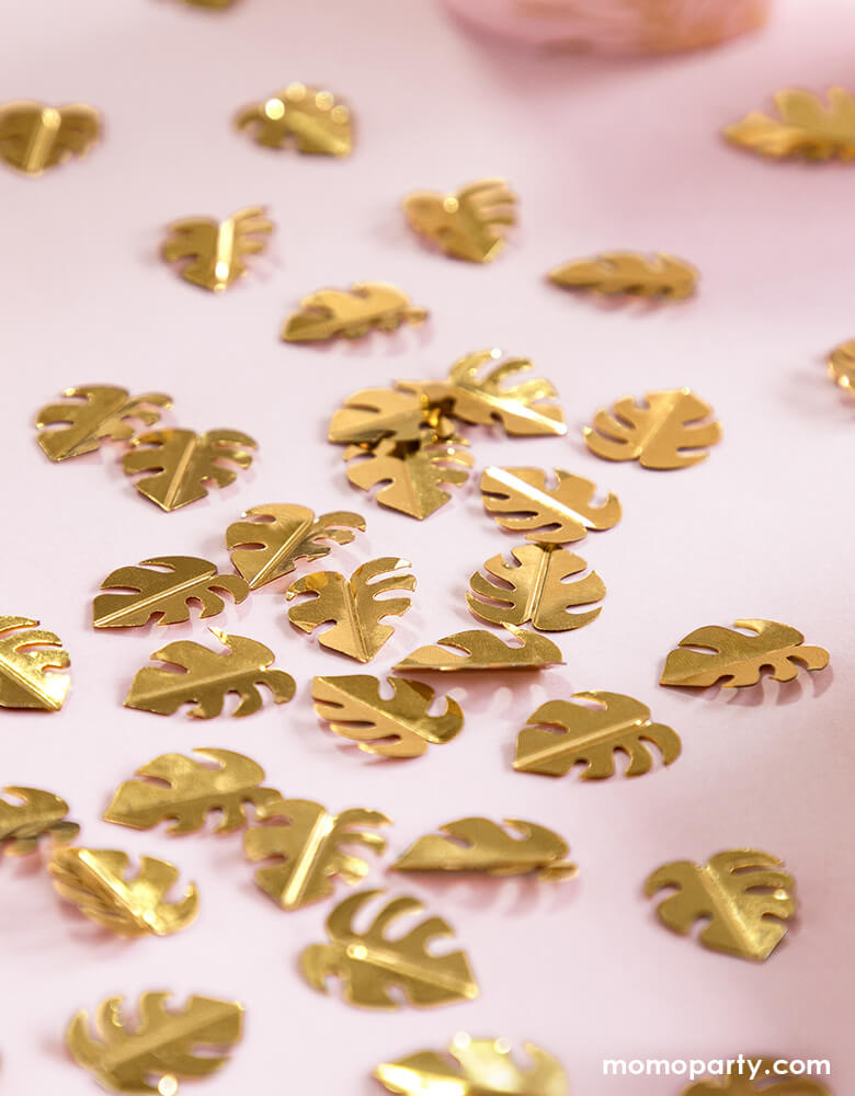 Party Deco Palm Leaf Gold Confetti on the pink table cloth. This confetti features Palm leaf shape cutouts with gold foil. Add some fun to your jungle, dinosaur or tropical themed party by spreading this set of palm leaf confetti in metallic gold to your table! party supply accessories Sold by Momopartys store provided modern party supplies, boutique party supplies, chic holiday party supplies and high end party supplies